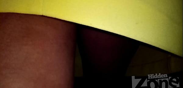  Upskirt of a tanned beauty without panties.